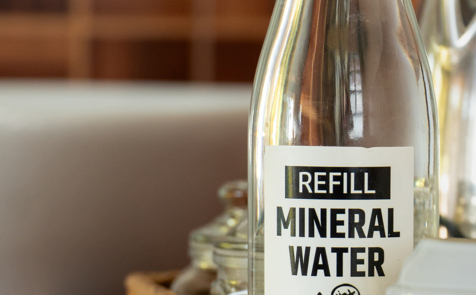 Refill mineral water bottle on a café table at Amed Café & Hotel Kebun Wayan