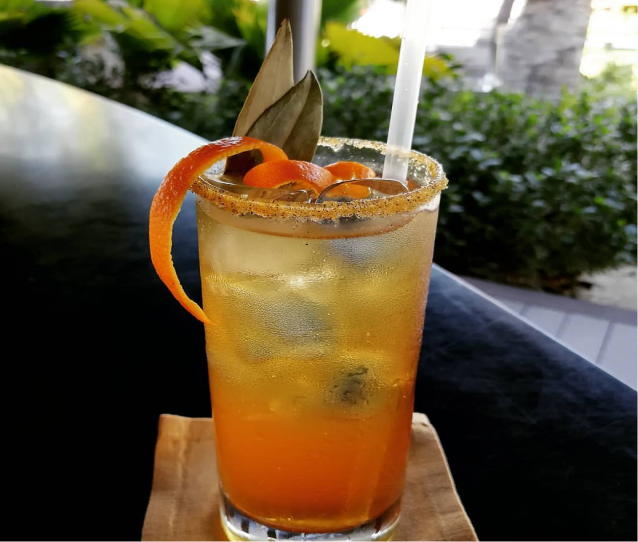 Orange cocktail with citrus peel garnish