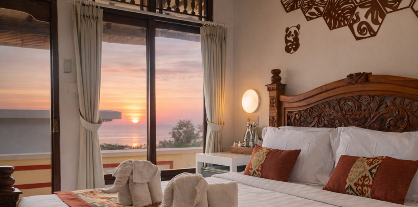 Bedroom with sunset ocean view at Amed Café & Hotel Kebun Wayan